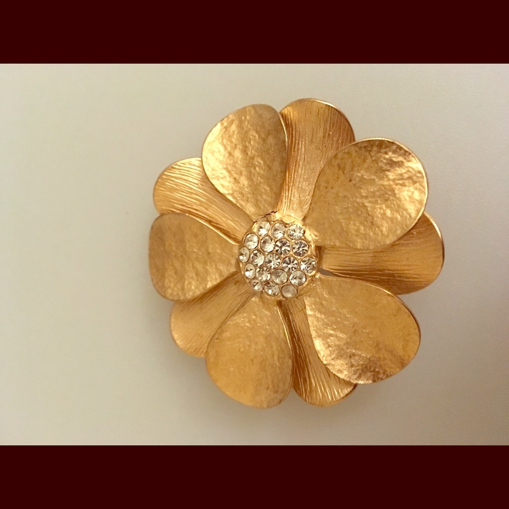 Golden flower pin with rhinestones in the middle